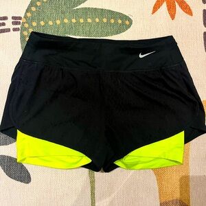 Nike athletic shorts with x3 pockets and built-in lemon compression shorts